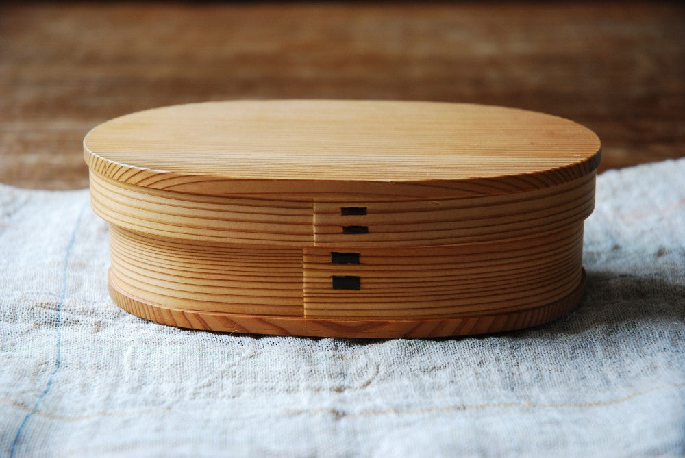 Wooden magewappa bento box on a towel