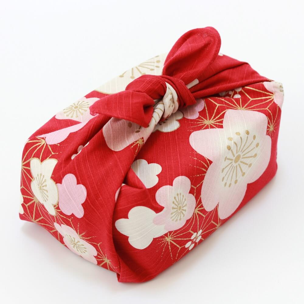 45 degree shot of bento box wrapped in asanoha plum red furoshiki