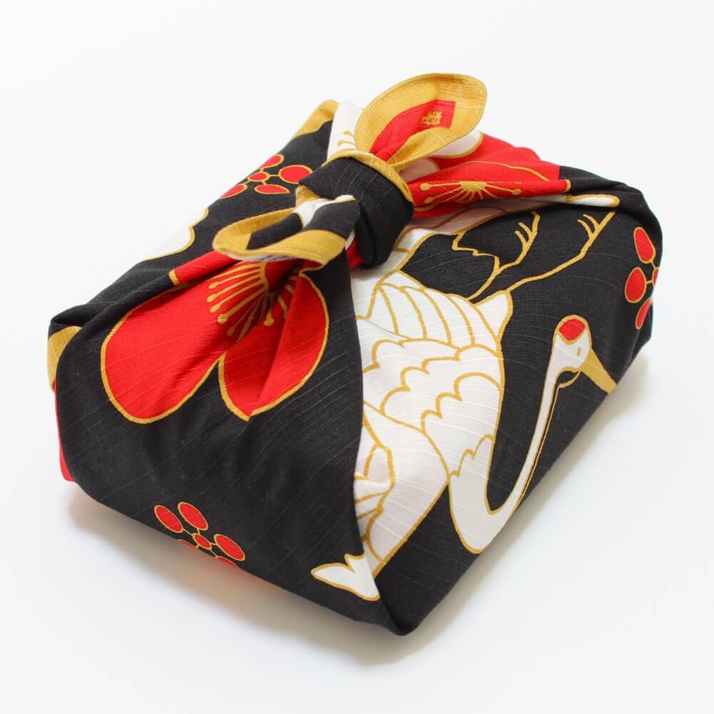 angle shot bento box wrapped in crane and turtle furoshiki