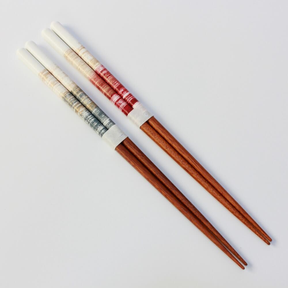 angled shot of the nene wood chopsticks blue and red