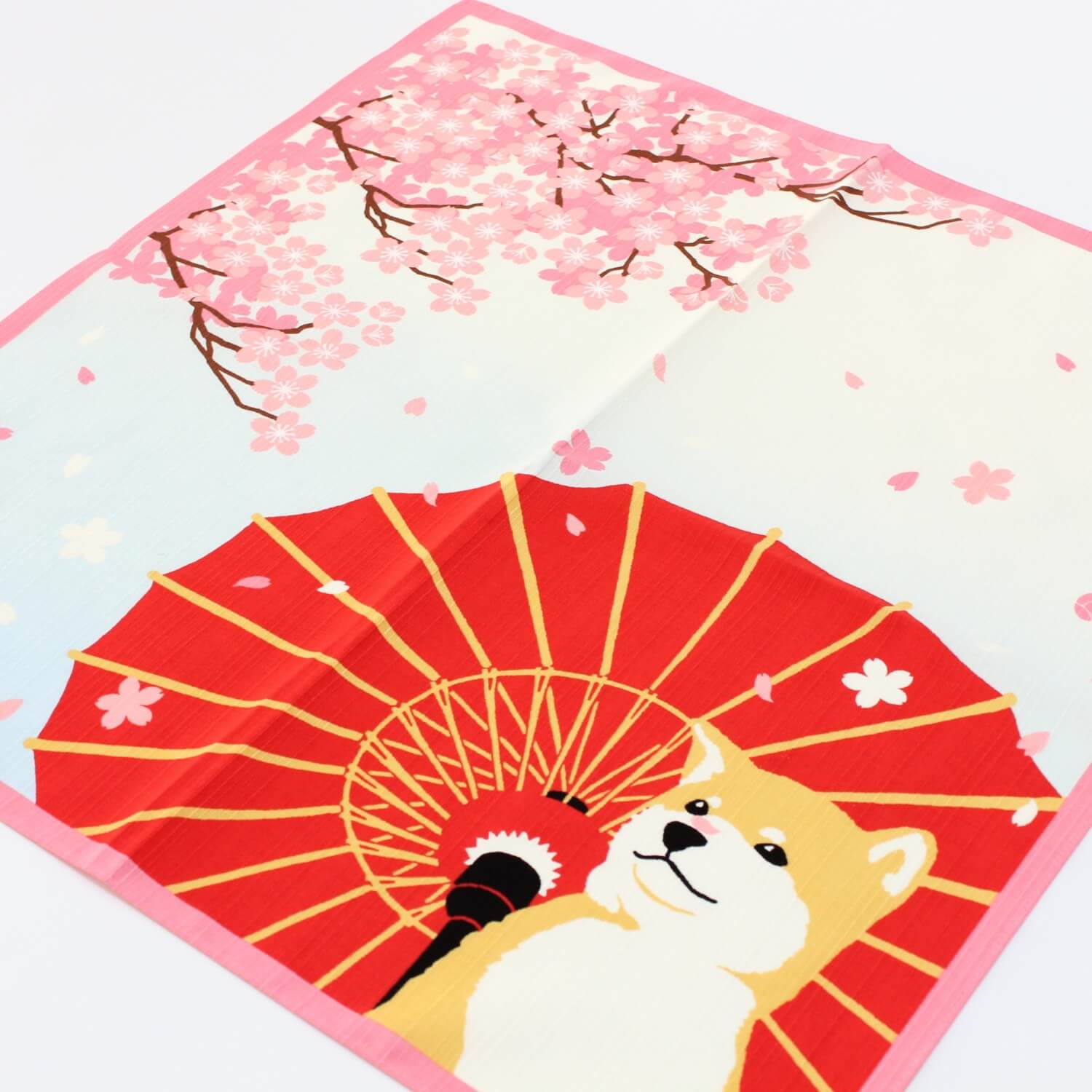fuller view of a furoshiki featuring shiba inu dog and sakura flowers
