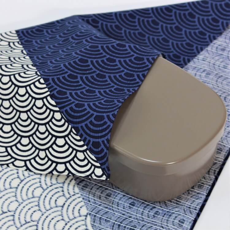 bento box covered with a blue wave furoshiki hama monyo