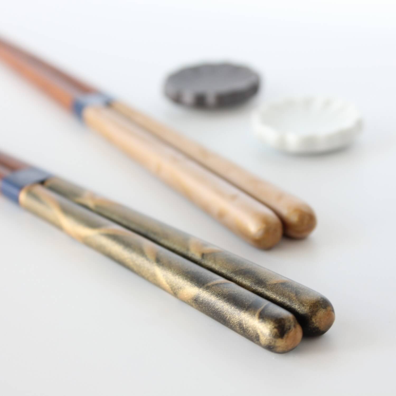 black gold chopsticks in the foreground