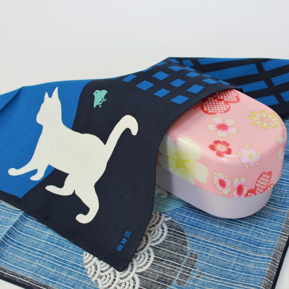 blue furoshiki covering a pink bento box