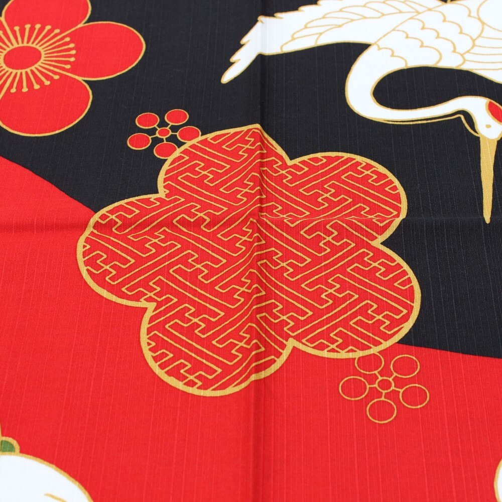 close up of centre plum flower with japanese manji pattern on furoshiki