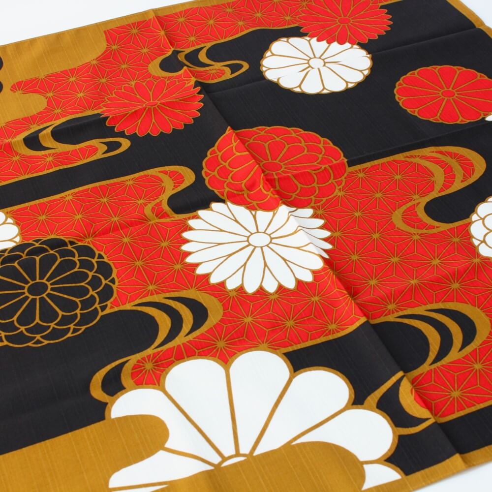 flatly laid furoshiki with red, white and black chrysanthemum patterns in a Japanese design