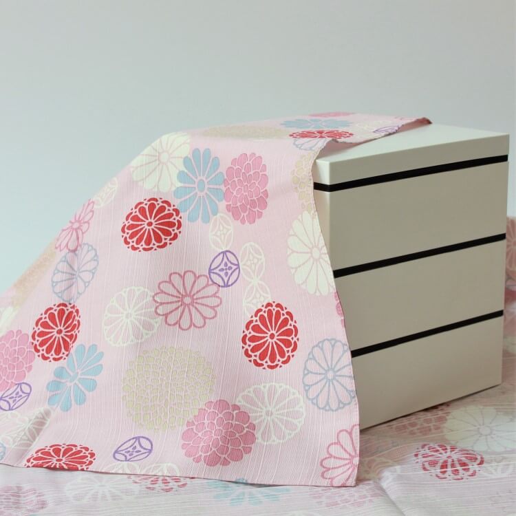 Pink furoshiki covering a picnic bento box