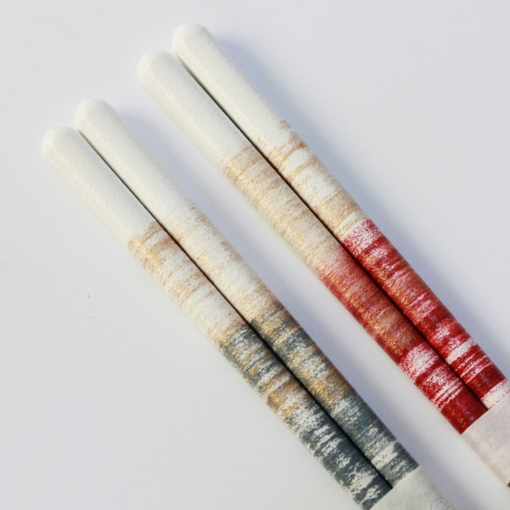 close up of handles of the nene chopsticks blue and red