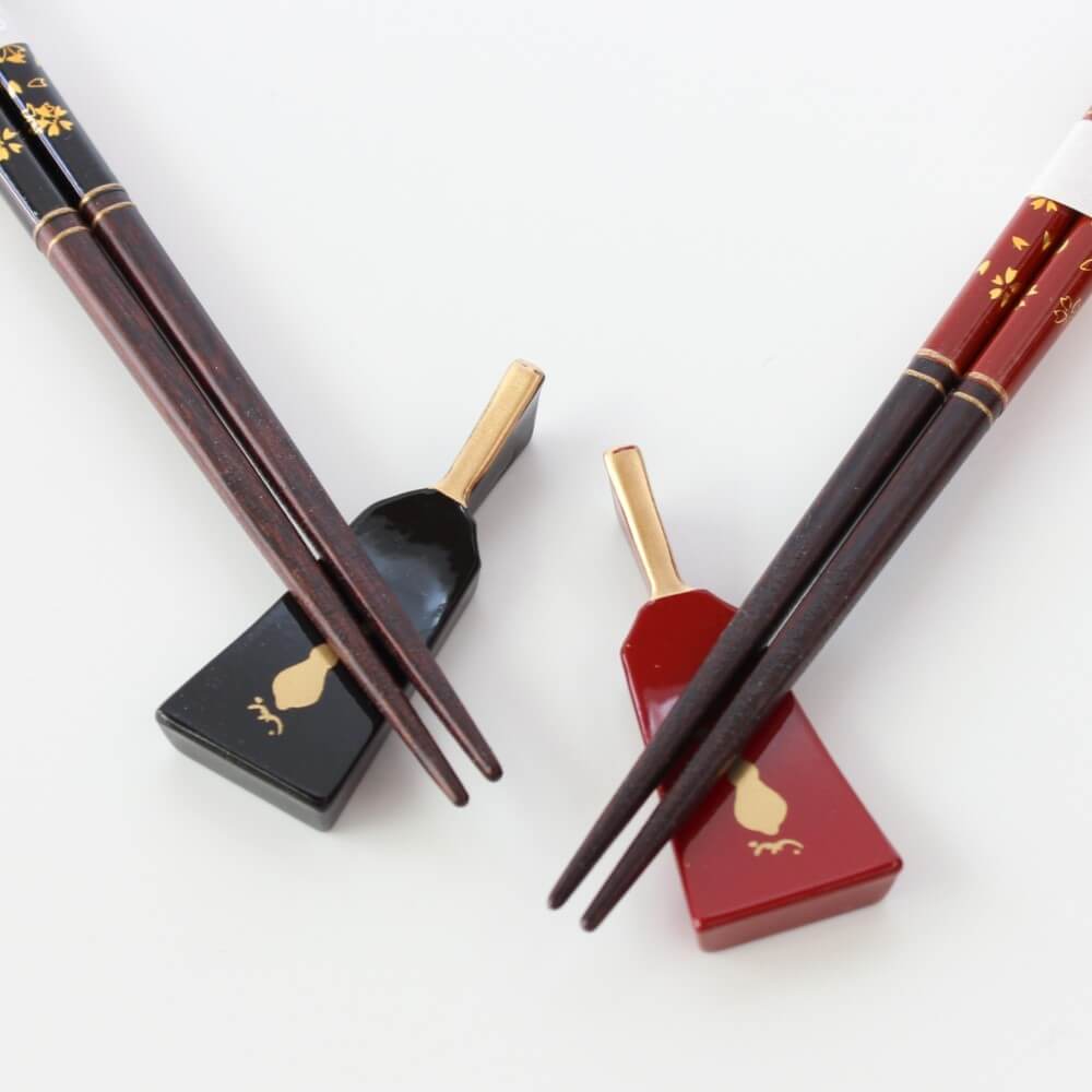 close up chopsticks tips on hagoita rests