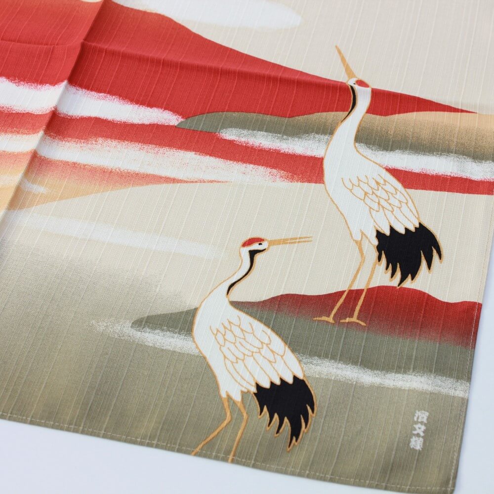 close up photo of cranes on furoshiki