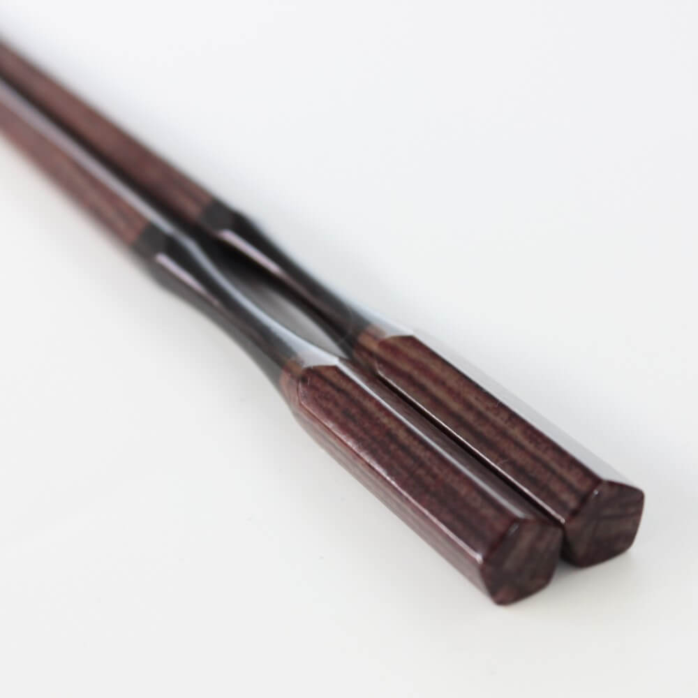 close up of handles of antique brown resin chopsticks