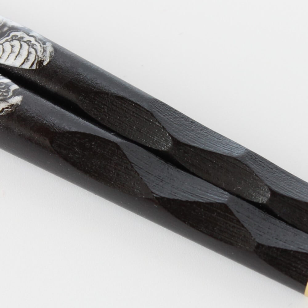 close up of carved handles of tenpyo dragon chopsticks