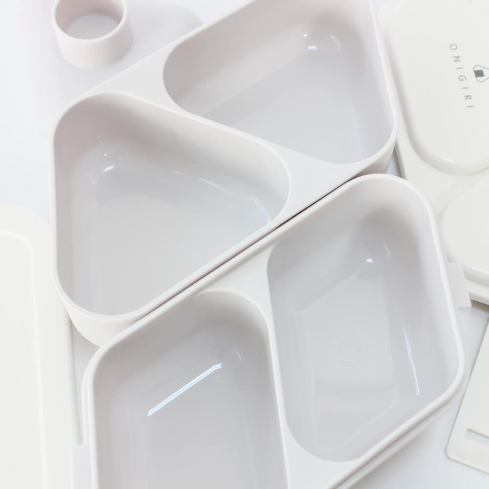close up showing inside compartments of 2 tiered onigiri bento case