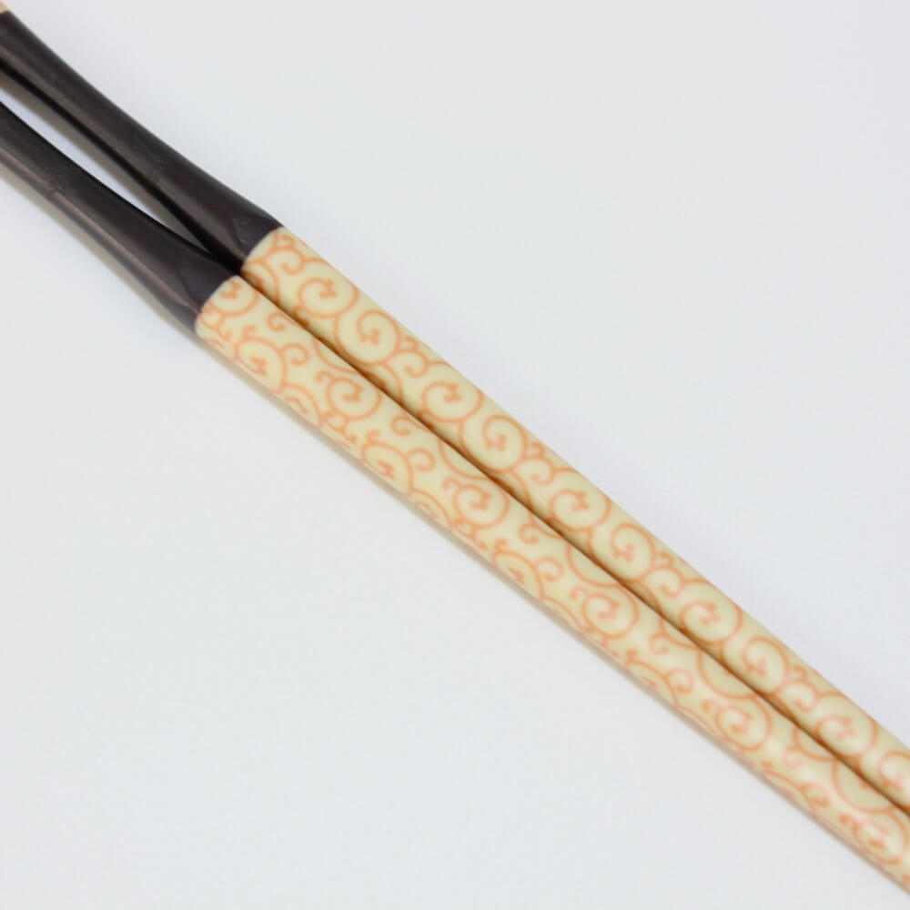 close up karakusa pattern on yellow chopsticks