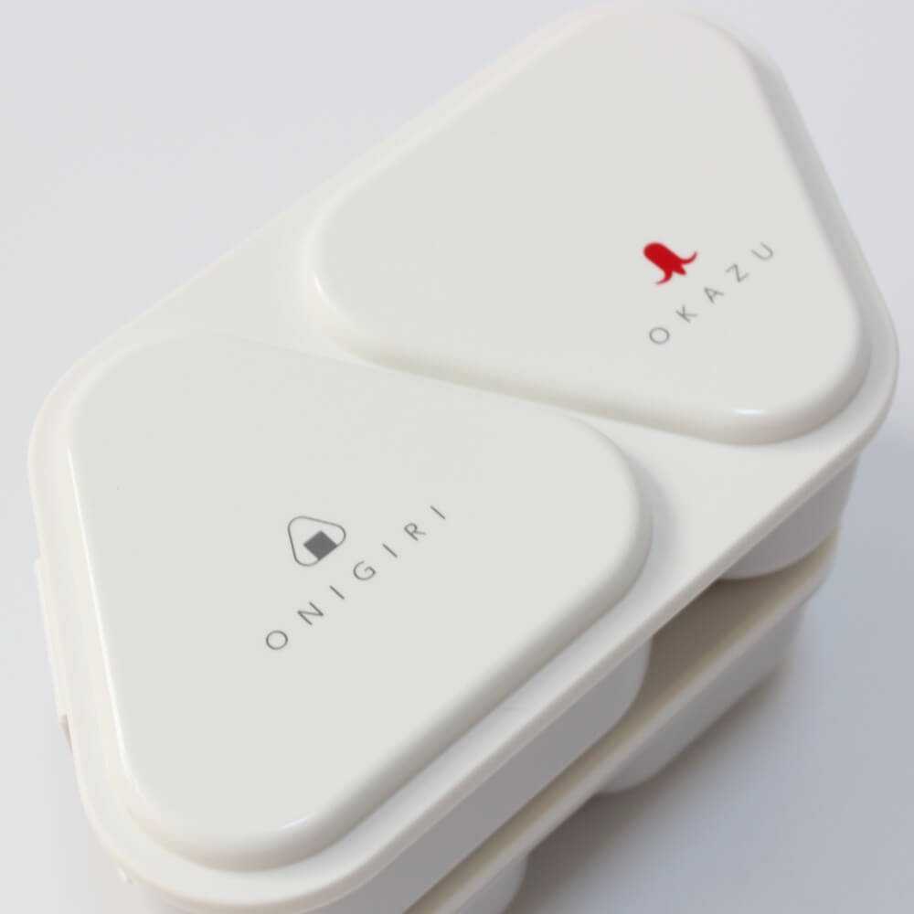 close up of lid of white 2 tiered onigiri bento case