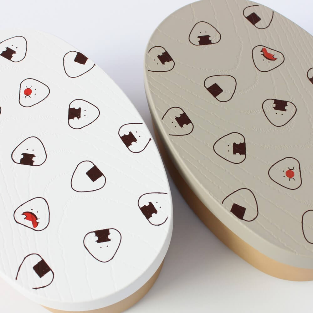 close up lids white grey onigiri bento box