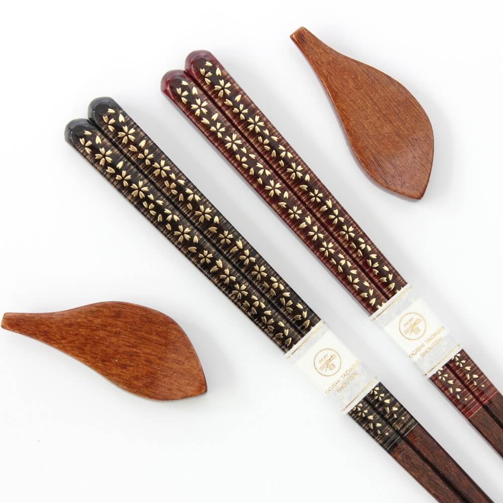 close up sakura gold chopsticks handles with rests