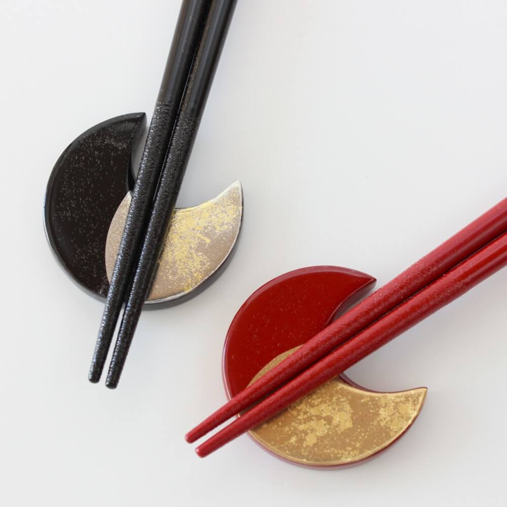 close up tips zuiun chopsticks on moon shaped rests
