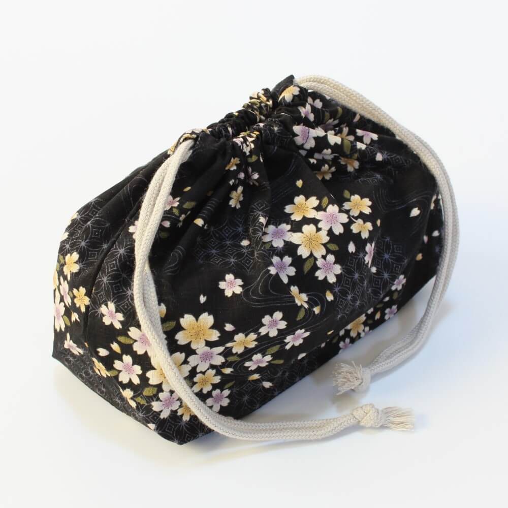 closed black bento lunch bag with sakura flower patterns