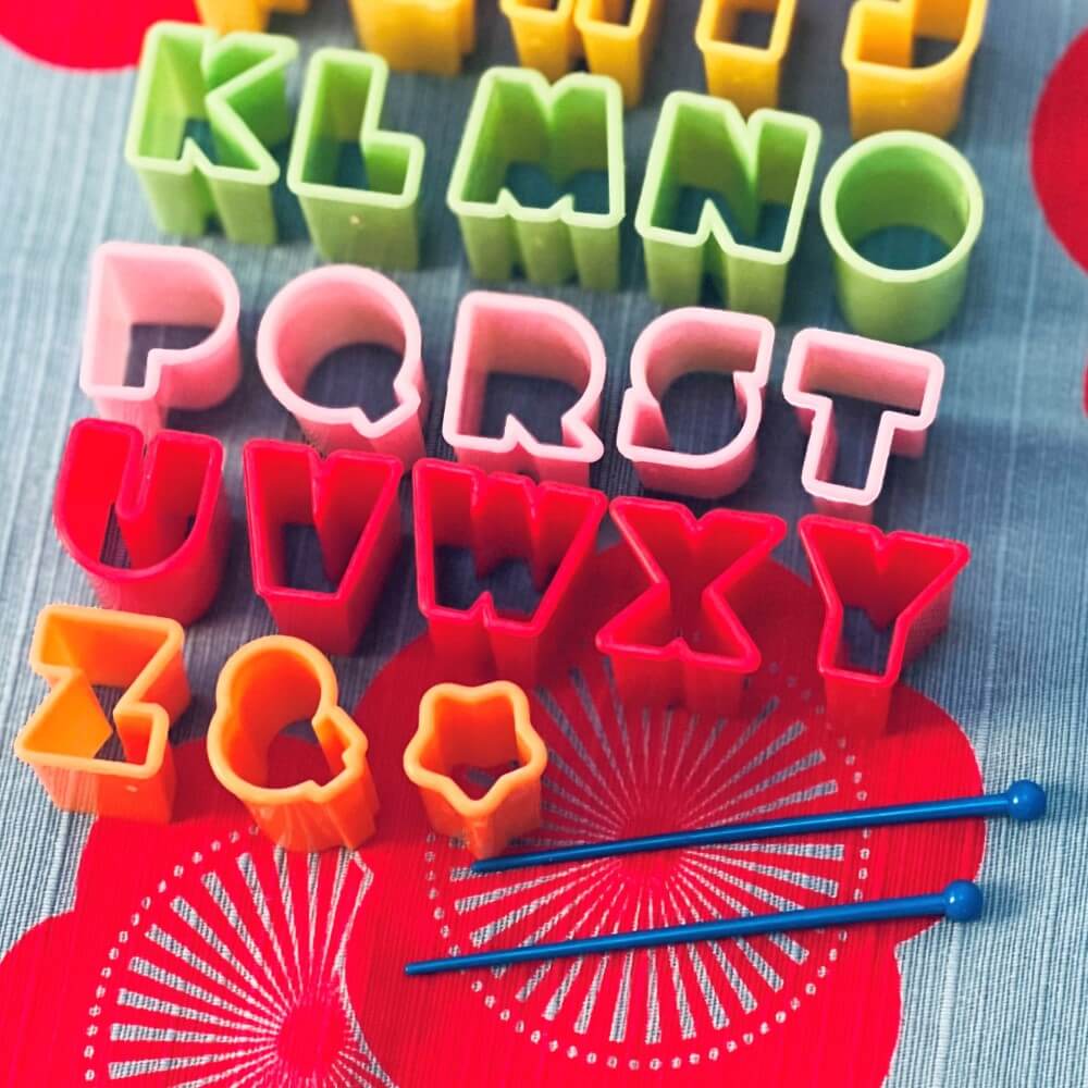 closeup alphabet food cutters with picks