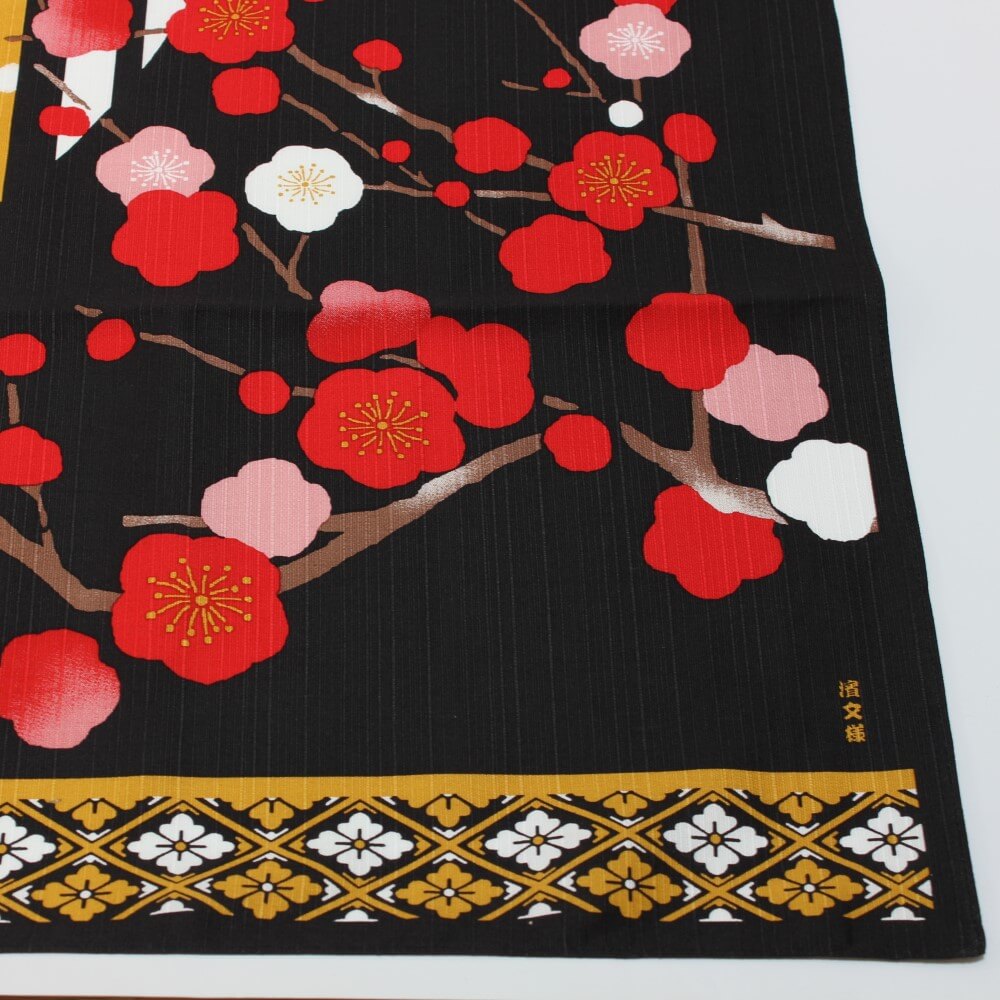 corner of crane dance furoshiki showing red plum flowers