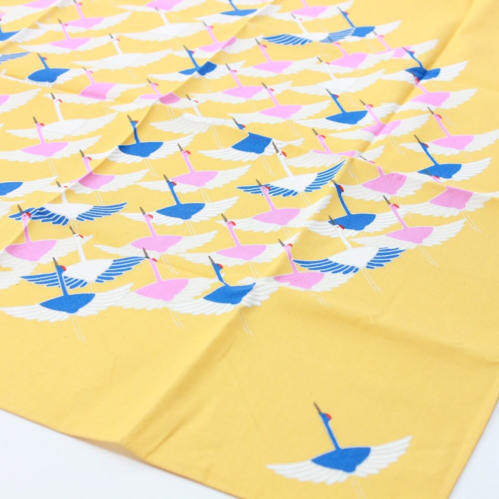 crane yellow furoshiki laid flat angled photo