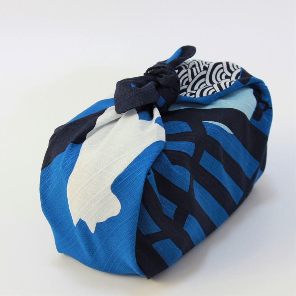 diagonal positioned bento box wrapped in cat lantern blue furoshiki