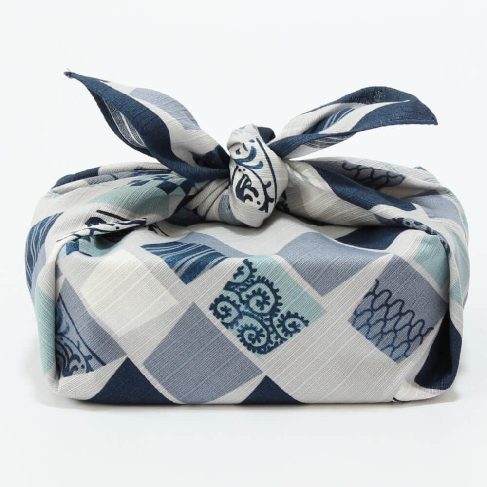 Blue and white patterned fabric wrapped in a decorative style on a white background