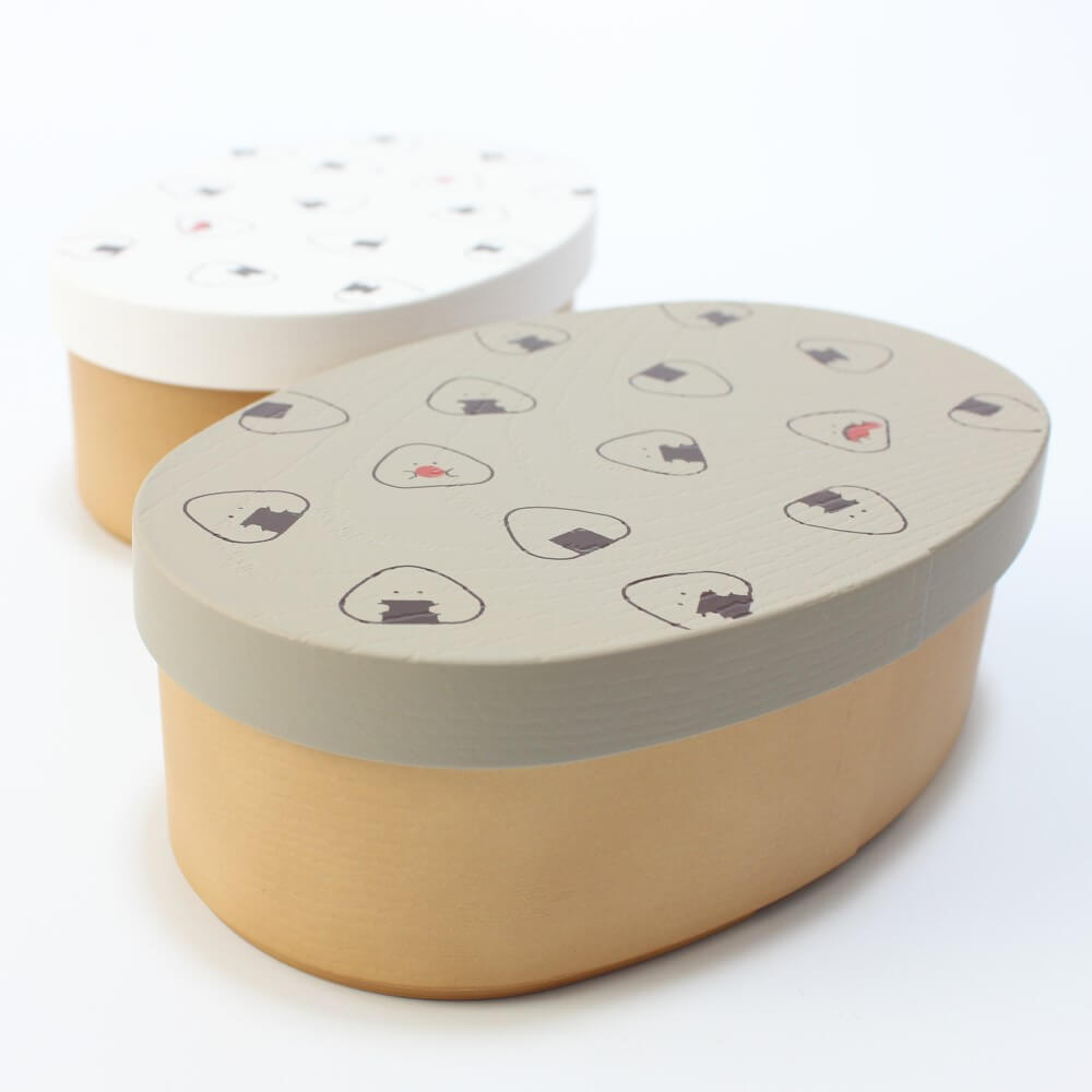 grey onigiri bento box photo from front angle