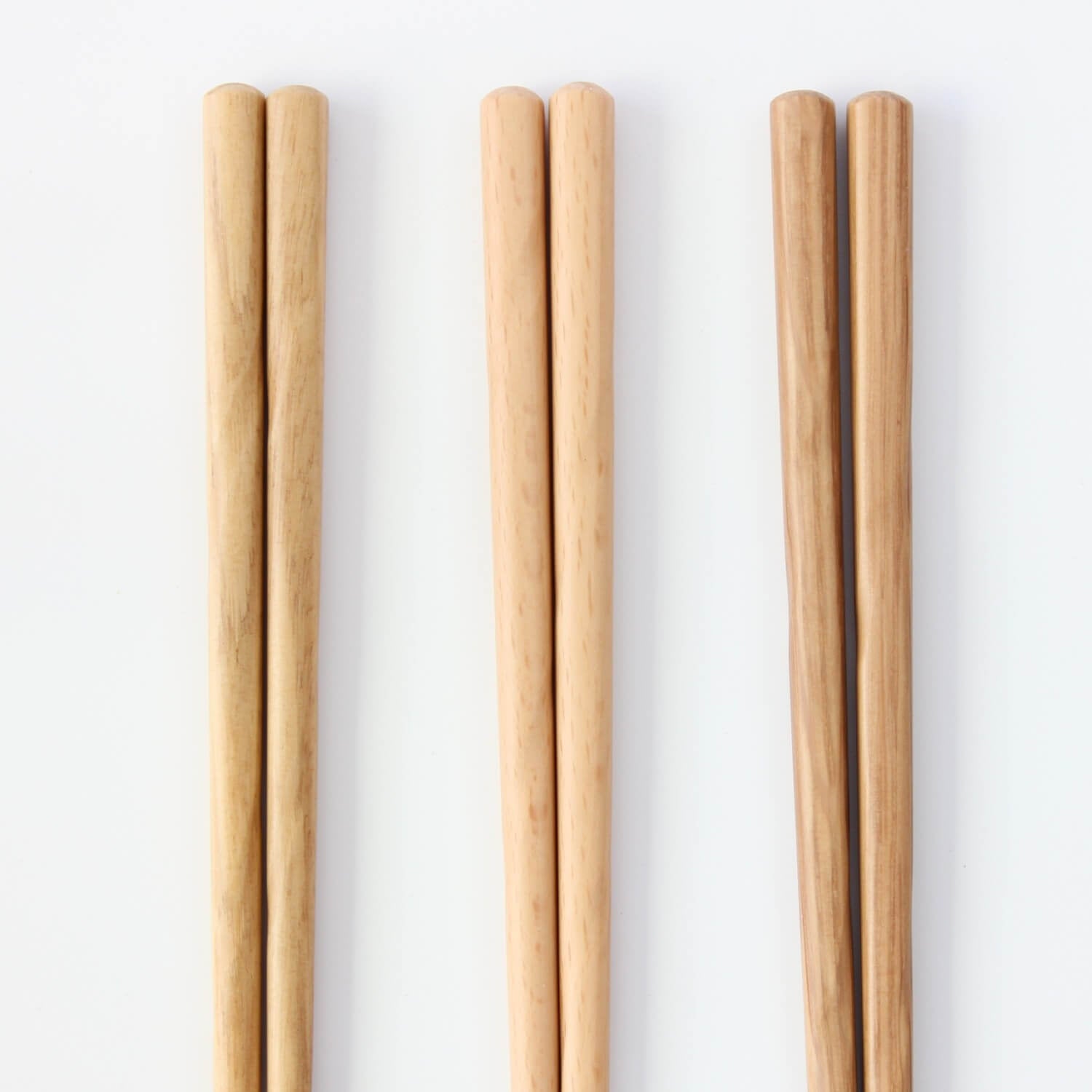 three wood chopsticks close up on handles