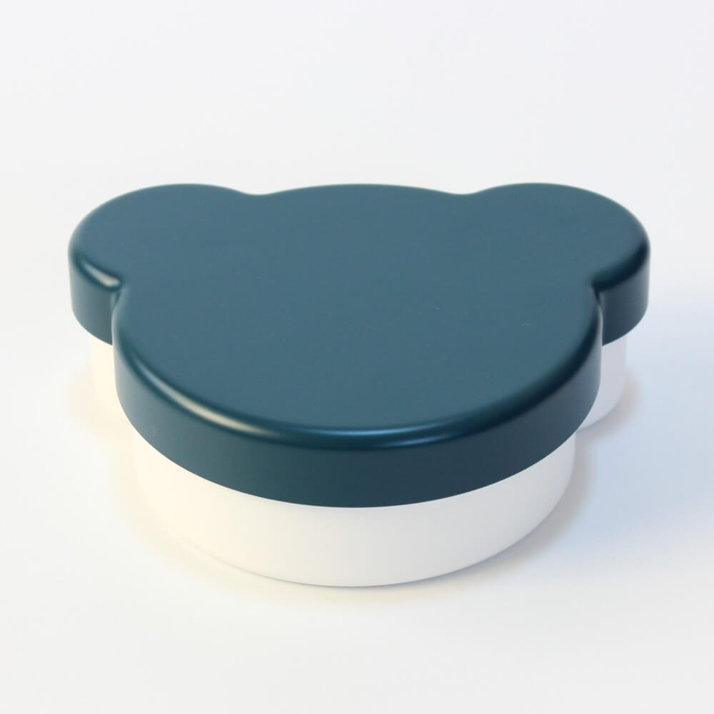 Container with a navy lid shaped like a bear on a white background