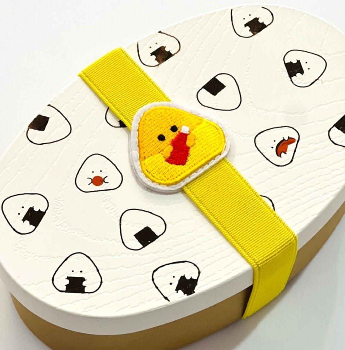 omurice bento lunch band securing lid of white onigiri bento box