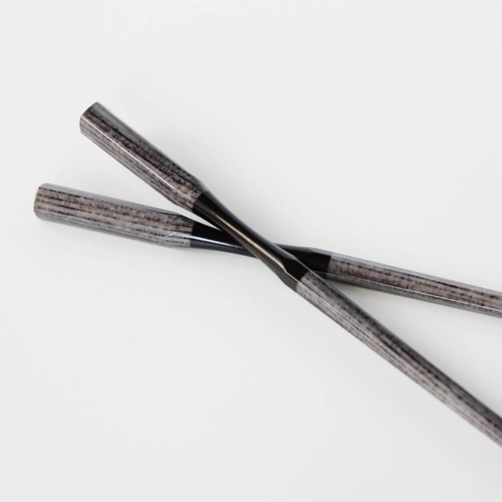 one chopsticks on another grey resin chopsticks