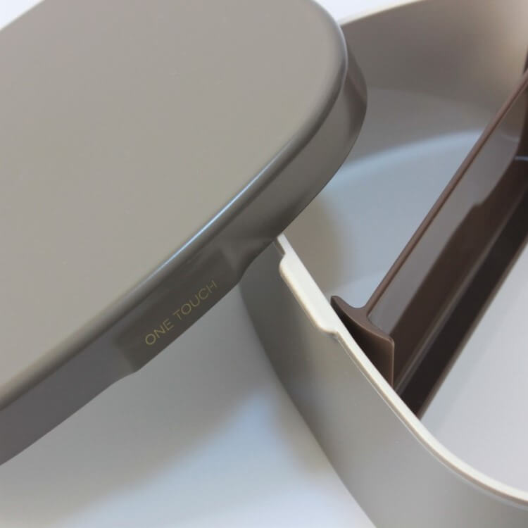 opened grey one touch bento box with lid leaning onto it