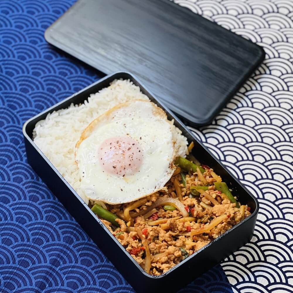 pad kra pao in charcoal black bento box