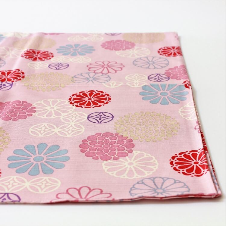 pink furoshiki chrysanthemum patterns laid out photo