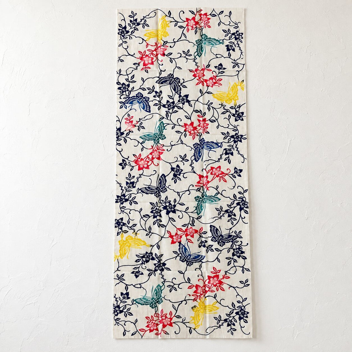 clematis and butterflies tenugui pattern on a white wall