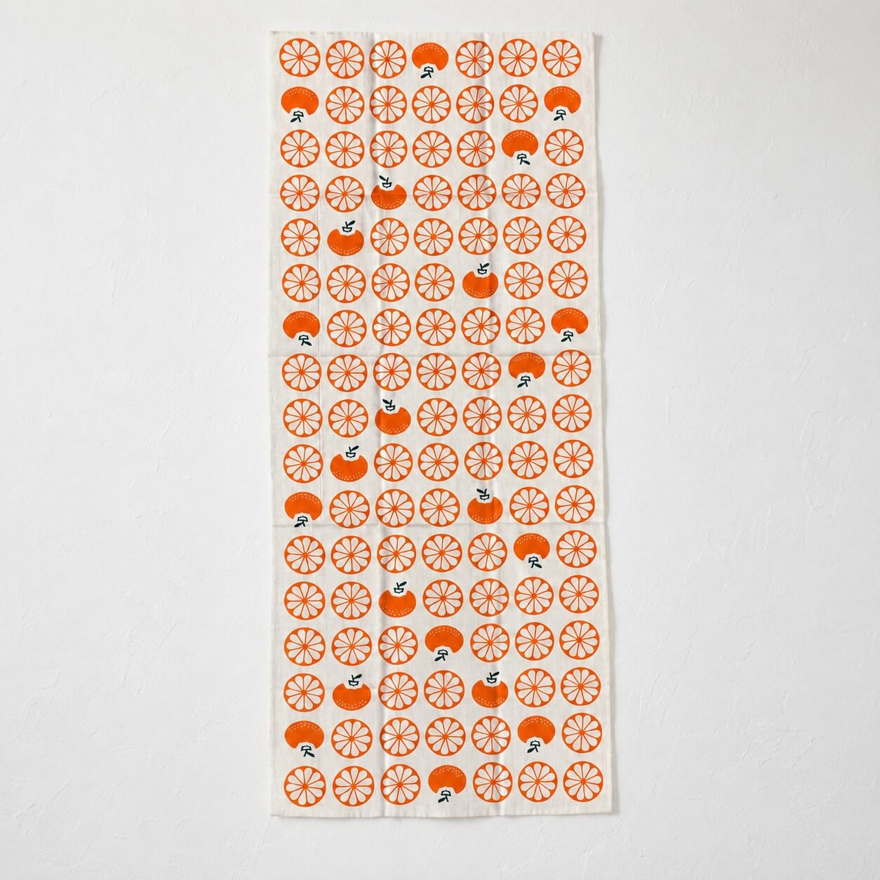 tenugui with japanese mandarin patterns laid flat on a white background