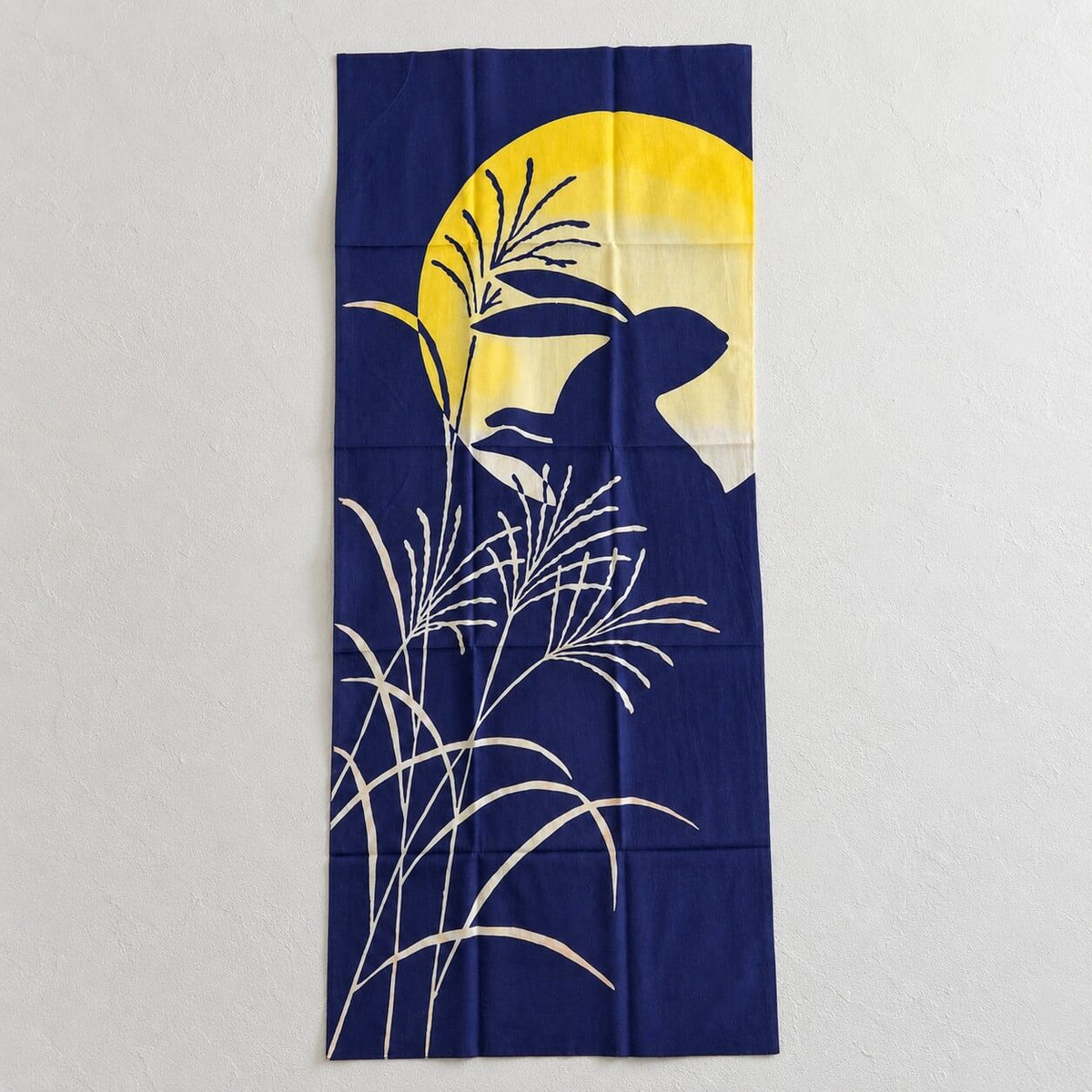 tenugui showing pampas grasses and rabbit silhouette with a full harvest moon in the background on a deep indigo night sky
