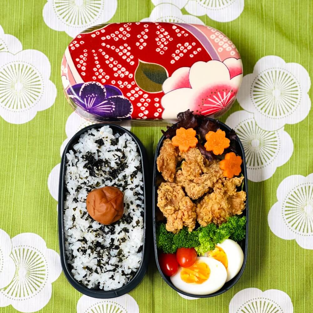 sakura blossoms oval bento box with food overhead shot