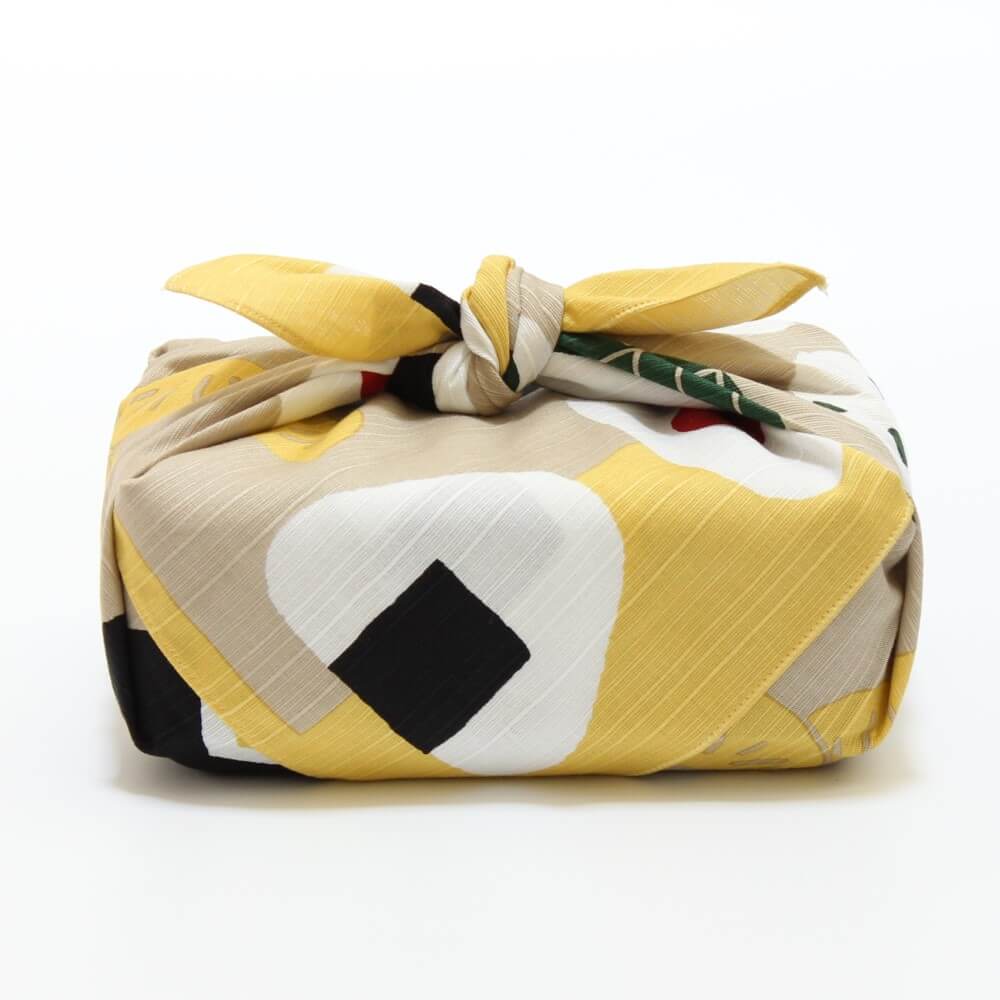 side profile of wrapped yellow onigiri furoshiki