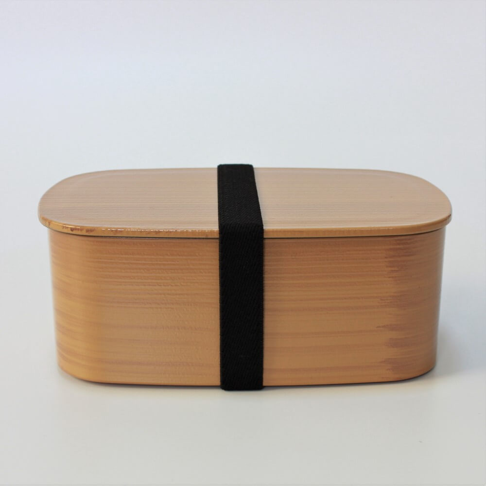 side view of hinoki 1 tier bento box with lunch band securing the lid