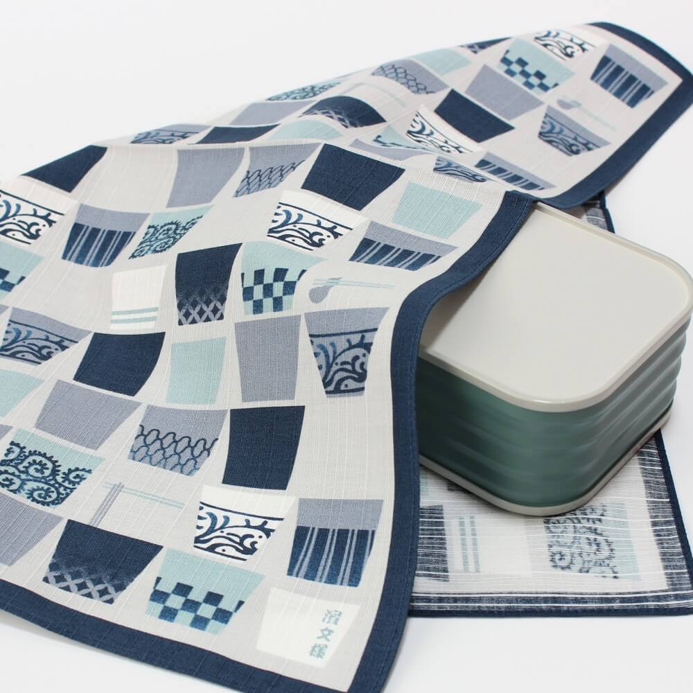 soba cups furoshiki covering a grey bento box