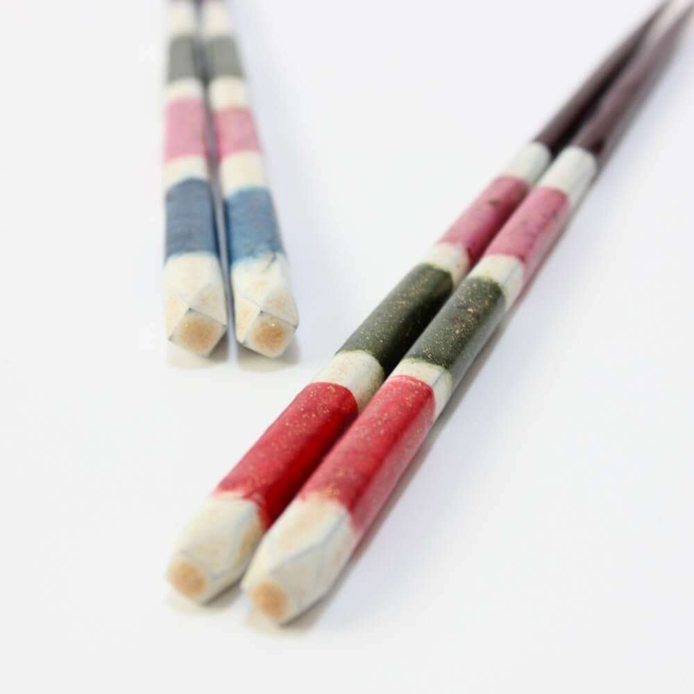 stylish shot of red yuushin chopsticks with blue version in the background