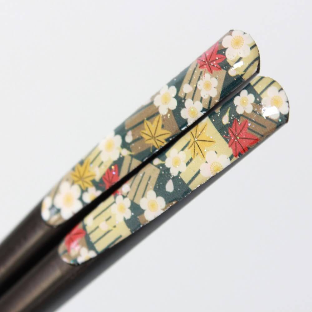 ultra close up shot showing glitter handles japanesque plum chopsticks