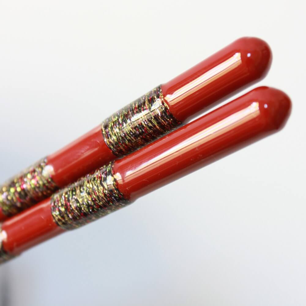 ultra closeup patterns in handles hananoito red chopsticks