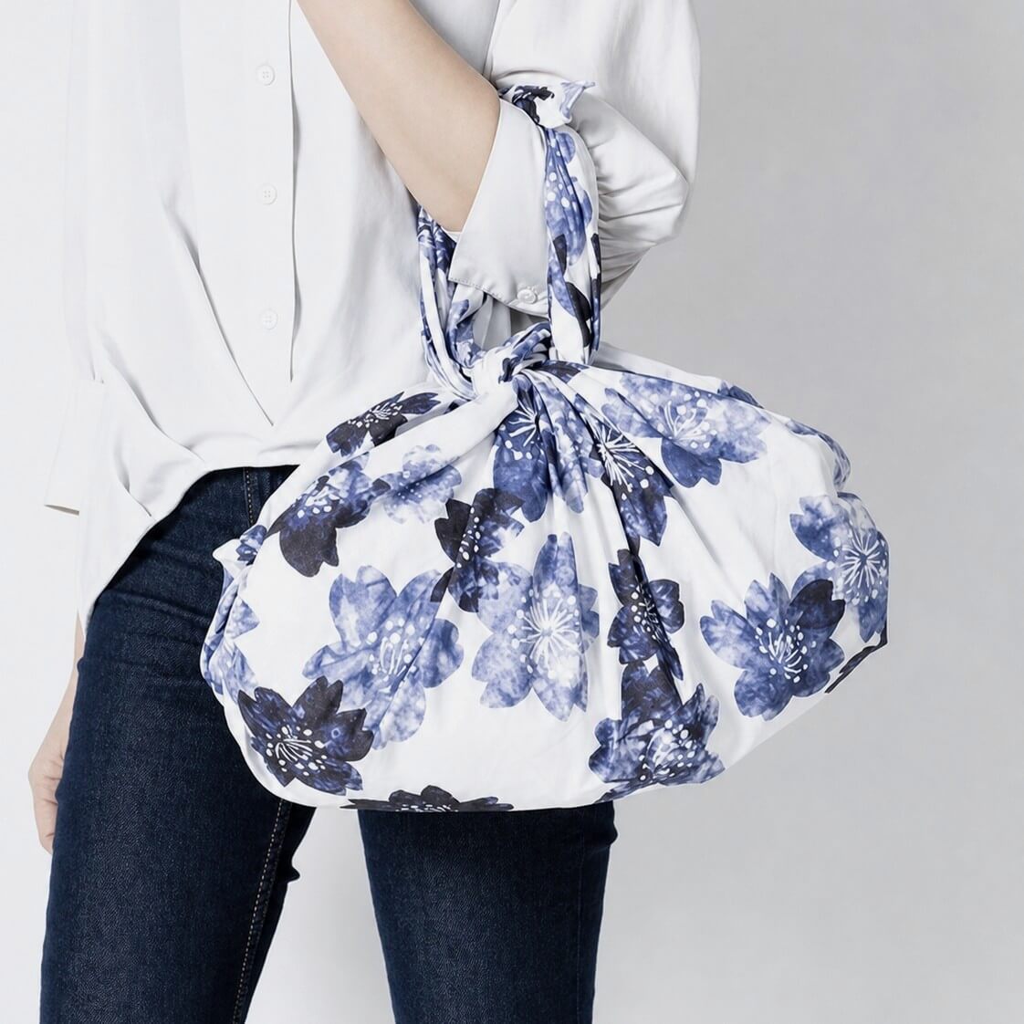 woman carrying an indigo dyed sakura furoshiki bag
