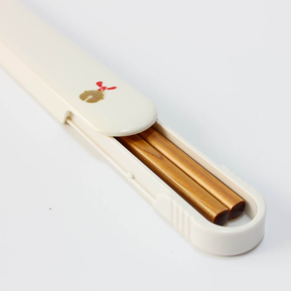 wooden chopsticks inside white chopsticks case