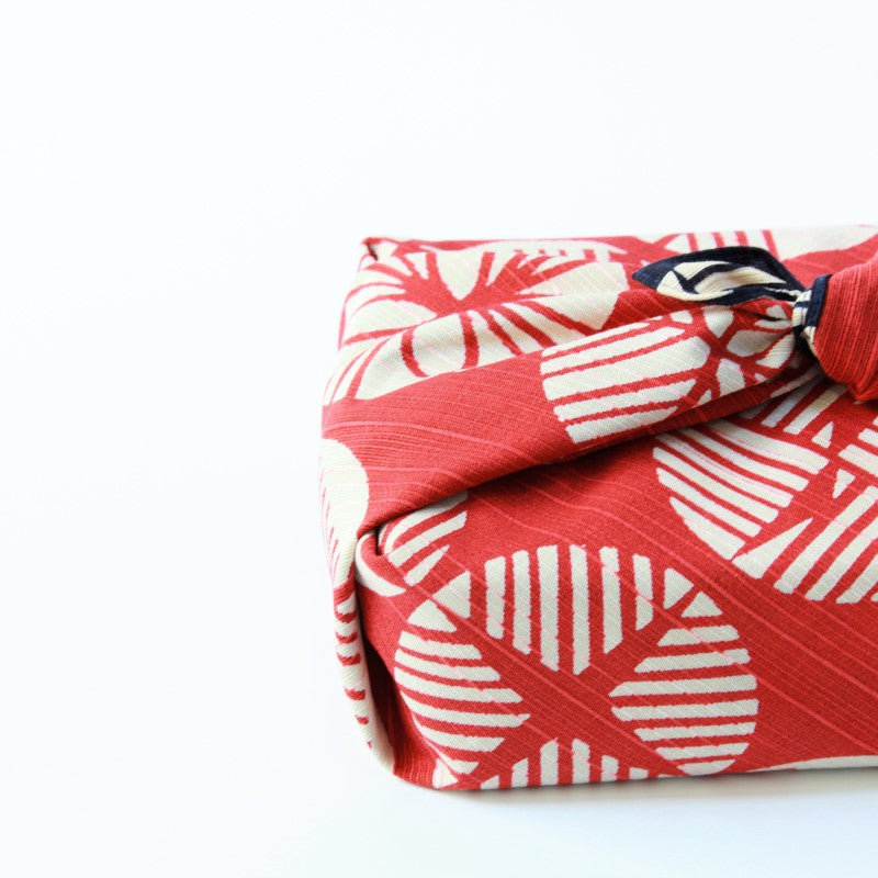 Isa Monyo furoshiki with pine pattern on red and navy blue backdrop