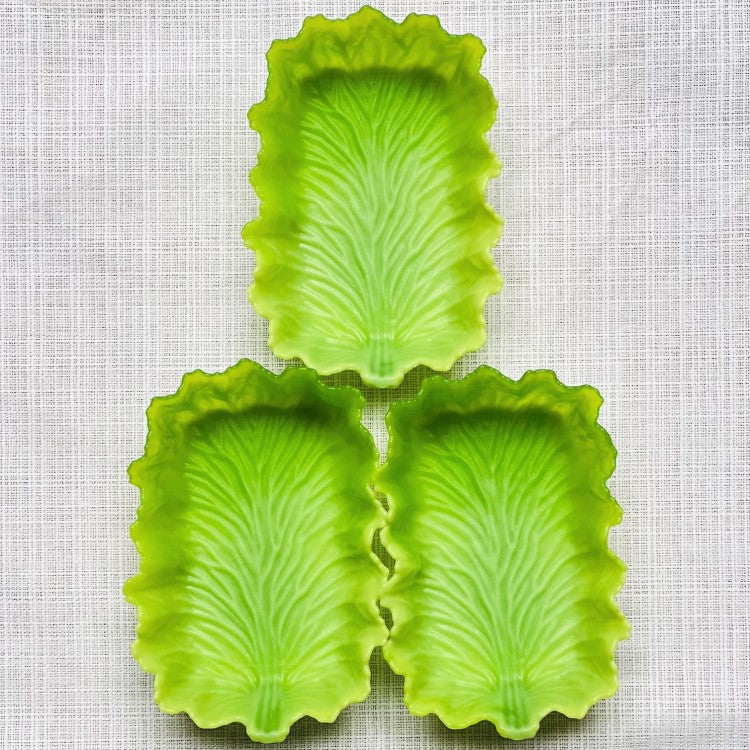Close up shot showing 3 green lettuce divider cups